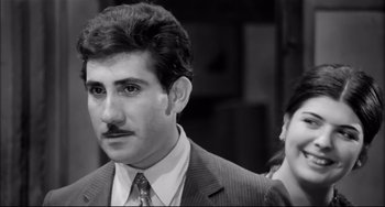 Movie still from “Seduced and Abandoned” (1964), directed by Pietro Germi – A black and white photo of a man and a woman; Close Up shot, Low angle