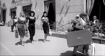 Movie still from “Seduced and Abandoned” (1964), directed by Pietro Germi – A couple of women walking down a sidewalk; Wide shot, Low angle