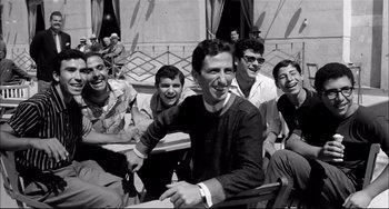 Movie still from “Seduced and Abandoned” (1964), directed by Pietro Germi – A black and white photo of a group of men sitting together; Medium shot, Low angle