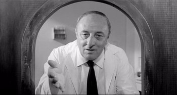 Movie still from “Seduced and Abandoned” (1964), directed by Pietro Germi – An older man wearing a white shirt and a tie; Close Up shot, Low angle