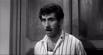 Movie still from “Seduced and Abandoned” (1964), directed by Pietro Germi – A black and white photo of a man with a mustache; Close Up shot, Low angle