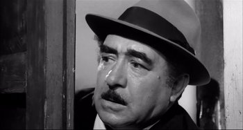 Movie still from “Seduced and Abandoned” (1964), directed by Pietro Germi – An older man with a hat and a mustache; Close Up shot, Low angle