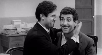 Movie still from “Seduced and Abandoned” (1964), directed by Pietro Germi – Two men in suits and ties one of which is holding the collar of another man's shirt; Close Up shot, Low angle