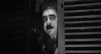 Movie still from “Seduced and Abandoned” (1964), directed by Pietro Germi – A black and white photo of a man with a mustache; Close Up shot, Low angle