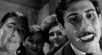 Movie still from “Seduced and Abandoned” (1964), directed by Pietro Germi – A black and white photo of a group of young people; Close Up shot, Low angle