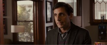 Movie still from “Seeking a Friend for the End of the World” (2012), directed by Lorene Scafaria – A person wearing a suit and tie; Close Up shot, Over the shoulder angle