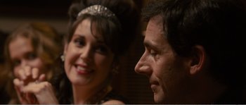 Movie still from “Seeking a Friend for the End of the World” (2012), directed by Lorene Scafaria – A man and a woman smiling for the camera; Close Up shot, Over the shoulder angle