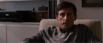 Movie still from “Seeking a Friend for the End of the World” (2012), directed by Lorene Scafaria – A person sitting in a chair; Close Up shot, Over the shoulder angle