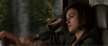 Movie still from “Seeking a Friend for the End of the World” (2012), directed by Lorene Scafaria – A woman sitting on a train looking out the window; Close Up shot, Over the shoulder angle