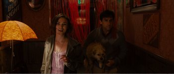 Movie still from “Seeking a Friend for the End of the World” (2012), directed by Lorene Scafaria – A man and a woman holding a dog; Medium shot, Over the shoulder angle