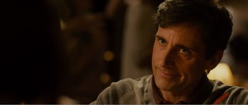 Movie still from “Seeking a Friend for the End of the World” (2012), directed by Lorene Scafaria – A person sitting in a room; Close Up shot, Over the shoulder angle