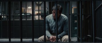 Movie still from “Seeking a Friend for the End of the World” (2012), directed by Lorene Scafaria – A man sitting on a bench in a jail cell; Medium shot, High angle