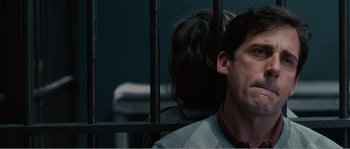 Movie still from “Seeking a Friend for the End of the World” (2012), directed by Lorene Scafaria – A man sitting in front of a woman behind bars; Close Up shot, Low angle