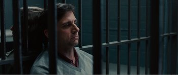 Movie still from “Seeking a Friend for the End of the World” (2012), directed by Lorene Scafaria – A man sitting behind bars in a jail cell; Close Up shot, Low angle