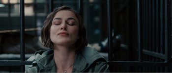 Movie still from “Seeking a Friend for the End of the World” (2012), directed by Lorene Scafaria – A woman with her eyes closed sitting on a bench; Close Up shot, High angle