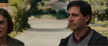 Movie still from “Seeking a Friend for the End of the World” (2012), directed by Lorene Scafaria – A person wearing a suit and tie; Close Up shot, Over the shoulder angle