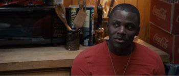 Movie still from “Seeking a Friend for the End of the World” (2012), directed by Lorene Scafaria – A person sitting at a table; Close Up shot, Over the shoulder angle