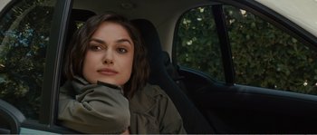 Movie still from “Seeking a Friend for the End of the World” (2012), directed by Lorene Scafaria – A woman sitting in the back seat of a car; Close Up shot, Over the shoulder angle