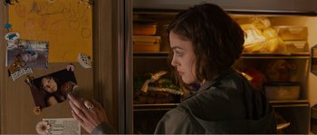 Movie still from “Seeking a Friend for the End of the World” (2012), directed by Lorene Scafaria – A woman standing in front of an open refrigerator; Close Up shot, Over the shoulder angle