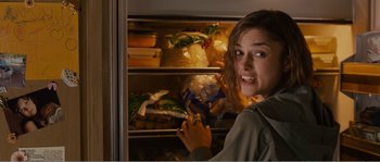 Movie still from “Seeking a Friend for the End of the World” (2012), directed by Lorene Scafaria – A woman looking in a refrigerator with food in it; Close Up shot, Over the shoulder angle