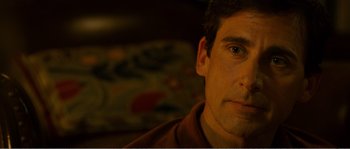 Movie still from “Seeking a Friend for the End of the World” (2012), directed by Lorene Scafaria – A man's face in a dark room; Close Up shot, Over the shoulder angle