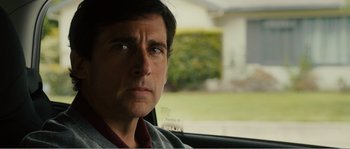 Movie still from “Seeking a Friend for the End of the World” (2012), directed by Lorene Scafaria – A person sitting in a car looking at the camera; Close Up shot, Over the shoulder angle