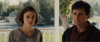 Movie still from “Seeking a Friend for the End of the World” (2012), directed by Lorene Scafaria – Two people standing next to each other in front of a tree; Medium shot, Over the shoulder angle