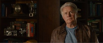 Movie still from “Seeking a Friend for the End of the World” (2012), directed by Lorene Scafaria – An older man in a leather jacket looking at the camera; Close Up shot, Over the shoulder angle