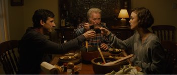 Movie still from “Seeking a Friend for the End of the World” (2012), directed by Lorene Scafaria – A group of people sitting at a table eating food; Medium shot, High angle