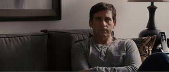 Movie still from “Seeking a Friend for the End of the World” (2012), directed by Lorene Scafaria – A person sitting on a couch; Close Up shot, Over the shoulder angle