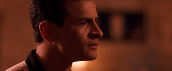 Movie still from “Selena” (1997), directed by Gregory Nava – A man's face in the dark; Close Up shot, Low angle