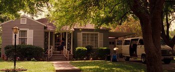 Movie still from “Selena” (1997), directed by Gregory Nava – A woman standing on the steps of a house; Extreme Wide shot, High angle