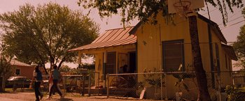 Movie still from “Selena” (1997), directed by Gregory Nava – An old house with a horse drawn carriage parked in front of it; Extreme Wide shot, Low angle