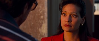 Movie still from “Selena” (1997), directed by Gregory Nava – A woman in a red jacket is looking at a man; Close Up shot, Over the shoulder angle