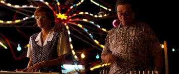 Movie still from “Selena” (1997), directed by Gregory Nava – Two people standing in front of a ferris wheel; Medium shot, Low angle