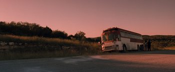 Movie still from “Selena” (1997), directed by Gregory Nava – A bus is parked on the side of the road; Extreme Wide shot, Low angle