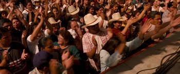 Movie still from “Selena” (1997), directed by Gregory Nava – A group of people in a crowd wearing hats; Medium shot, High angle