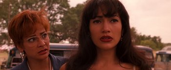 Movie still from “Selena” (1997), directed by Gregory Nava – A person with long black hair; Close Up shot, Over the shoulder angle