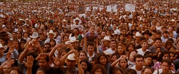 Movie still from “Selena” (1997), directed by Gregory Nava – A large group of people gathered in the street; Wide shot, High angle