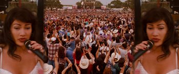 Movie still from “Selena” (1997), directed by Gregory Nava – A large crowd of people at an outdoor concert; Extreme Wide shot, High angle