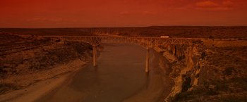 Movie still from “Selena” (1997), directed by Gregory Nava – A bridge over a river with a truck on it's side; Extreme Wide shot, High angle