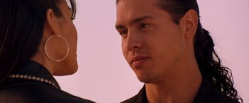 Movie still from “Selena” (1997), directed by Gregory Nava – A man's face as he stares into the distance; Close Up shot, Over the shoulder angle