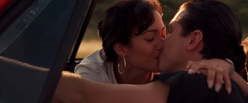 Movie still from “Selena” (1997), directed by Gregory Nava – A man and a woman kissing in the back of a car; Close Up shot, High angle