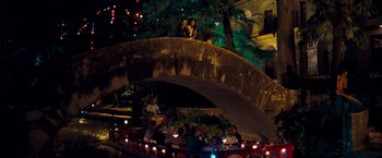 Movie still from “Selena” (1997), directed by Gregory Nava – People are sitting on a bridge at night; Extreme Wide shot, High angle