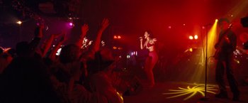 Movie still from “Selena” (1997), directed by Gregory Nava – A woman singing into a microphone in front of a crowd; Wide shot, Low angle