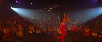 Movie still from “Selena” (1997), directed by Gregory Nava – A woman in a red outfit performing in front of an audience; Wide shot, Low angle