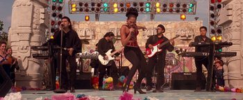 Movie still from “Selena” (1997), directed by Gregory Nava – A group of people performing on a stage with guitars; Wide shot, Low angle
