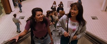 Movie still from “Selena” (1997), directed by Gregory Nava – Two young women standing next to each other in front of a crowd; Medium shot, High angle