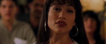 Movie still from “Selena” (1997), directed by Gregory Nava – A person with a lip piercing; Close Up shot, Over the shoulder angle
