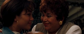 Movie still from “Selena” (1997), directed by Gregory Nava – A woman and a young girl smiling at each other; Close Up shot, Over the shoulder angle
